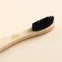 Bamboo toothbrush close-up - soft bristles and natural bamboo grain